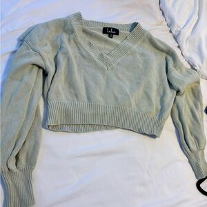 Light green sweater. Size small, V lined around the neck.